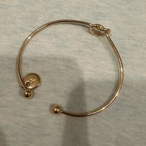Gold bracelet. Has a small P charm.